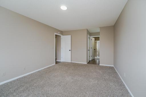 Primary bedroom w/ on suite 3/4 bath and walk-in closet w/ built-ins.
