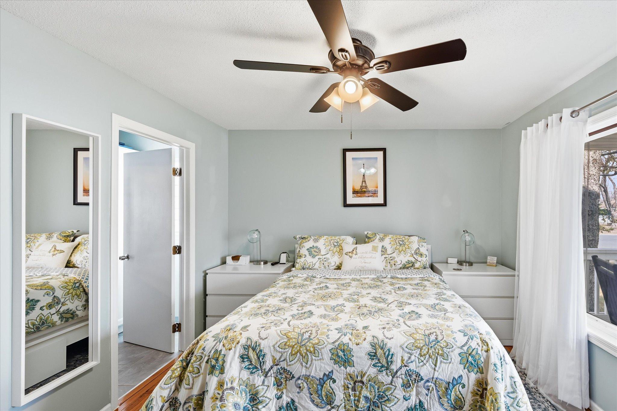 Main level primary bedroom with 3/4 bath and walk in closet