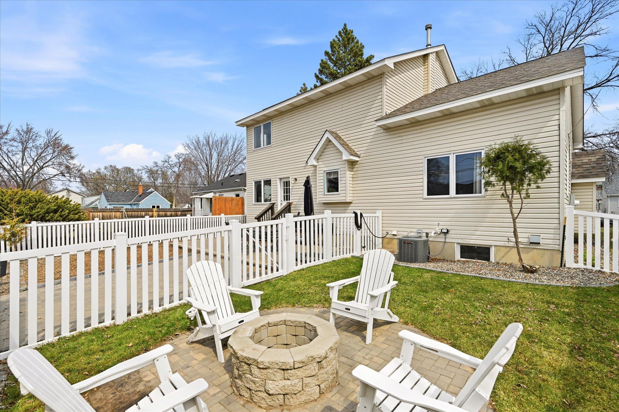 Fully fenced backyard with paver patio and fire pit