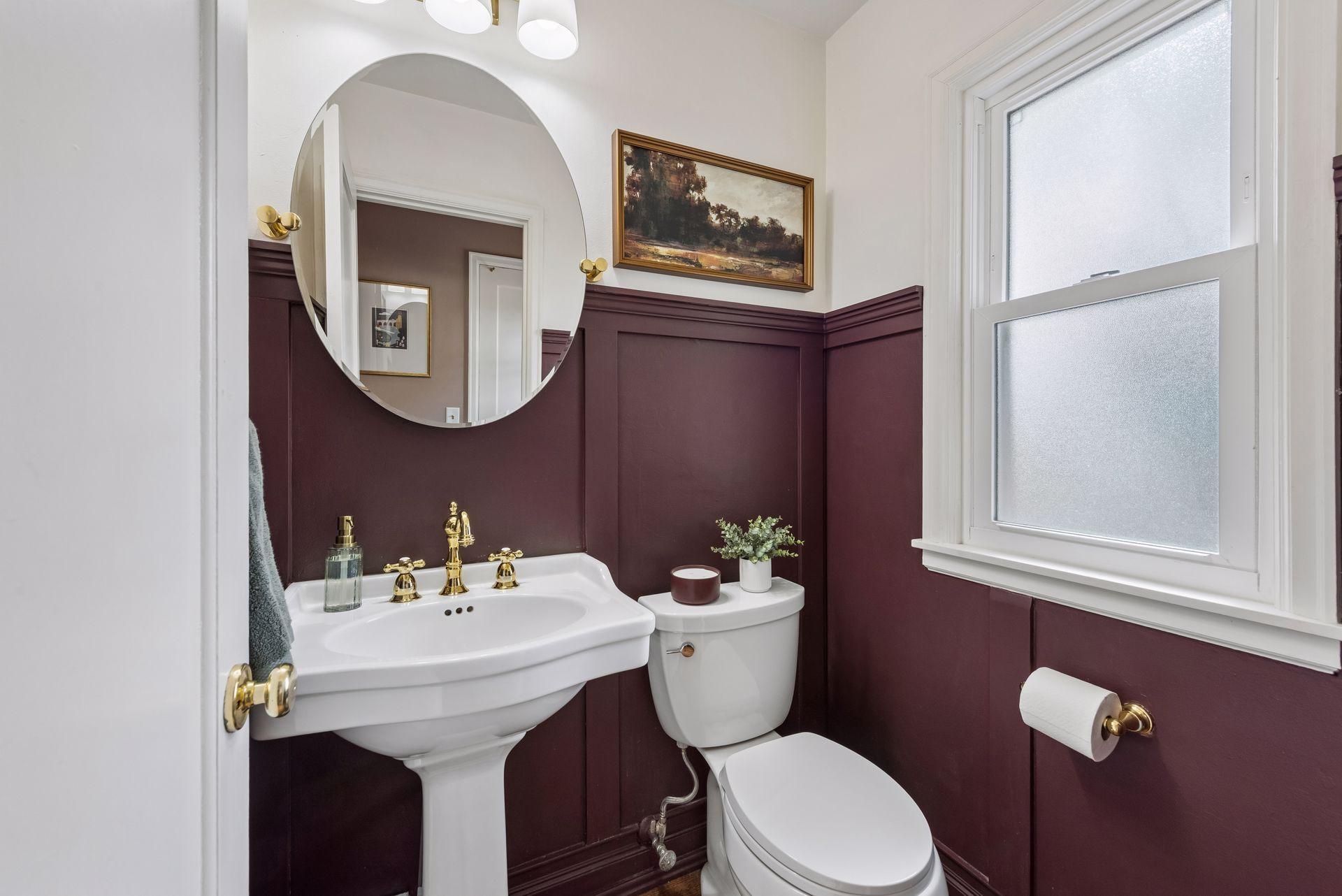 A fully updated main-floor half bath features classic wainscoting with stylish finishes.