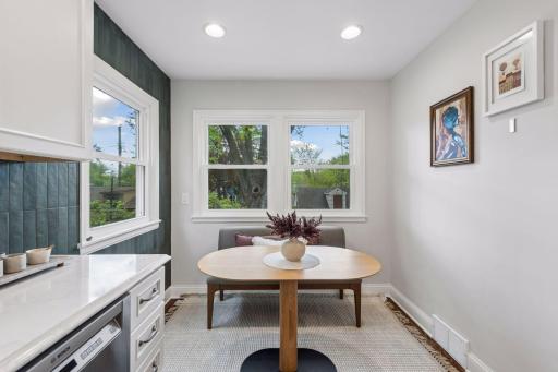 A charming breakfast nook offers a cozy additional space for casual dining or enjoying your morning coffee.