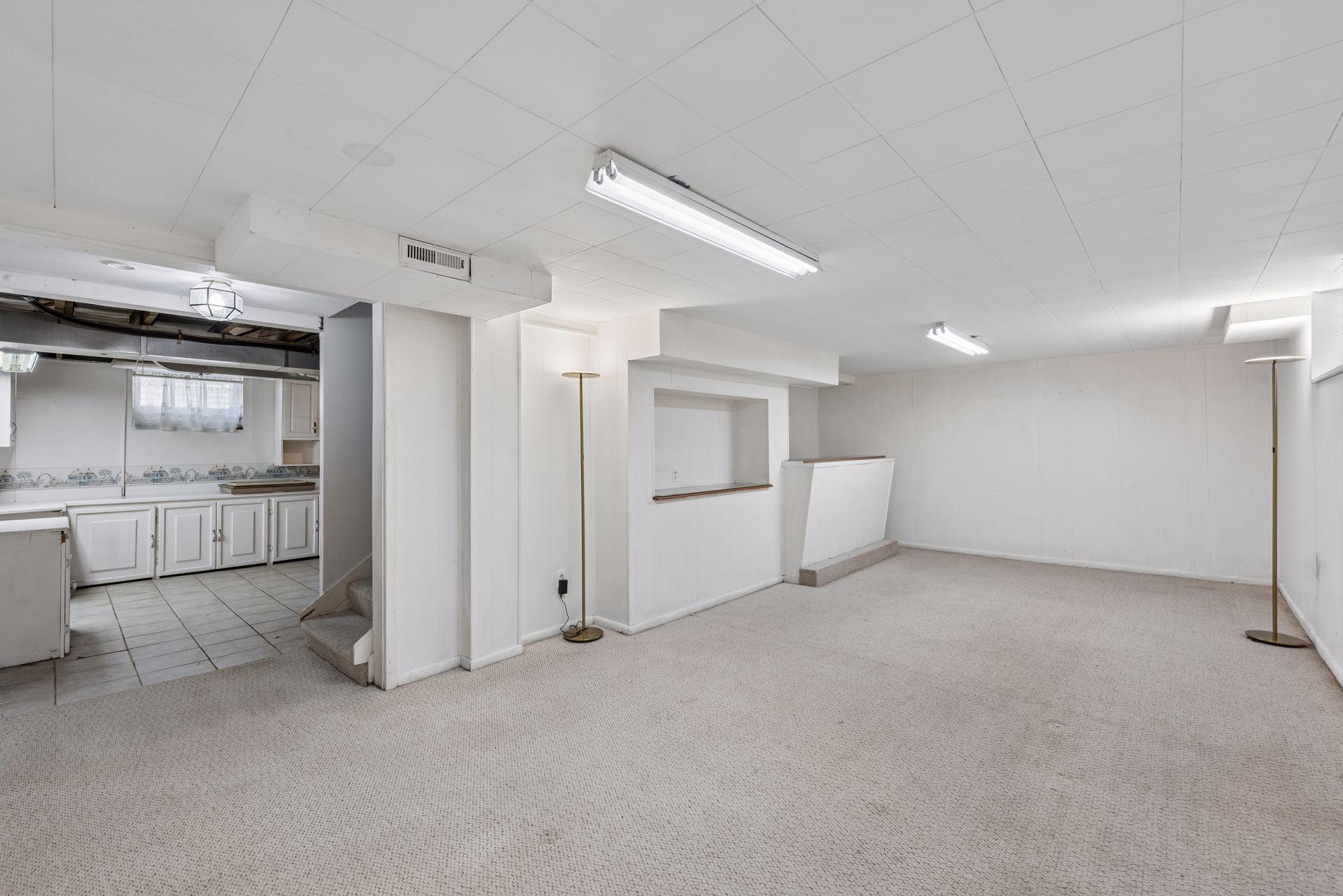 A large lower-level family room offers incredible potential and is ready for your finishing touches to make it your own.