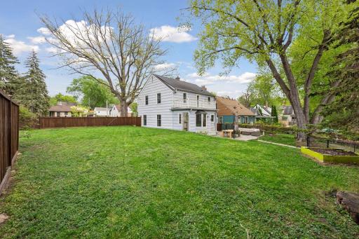 A spacious, flat backyard offers plenty of room for outdoor activities, gardening, and entertaining.