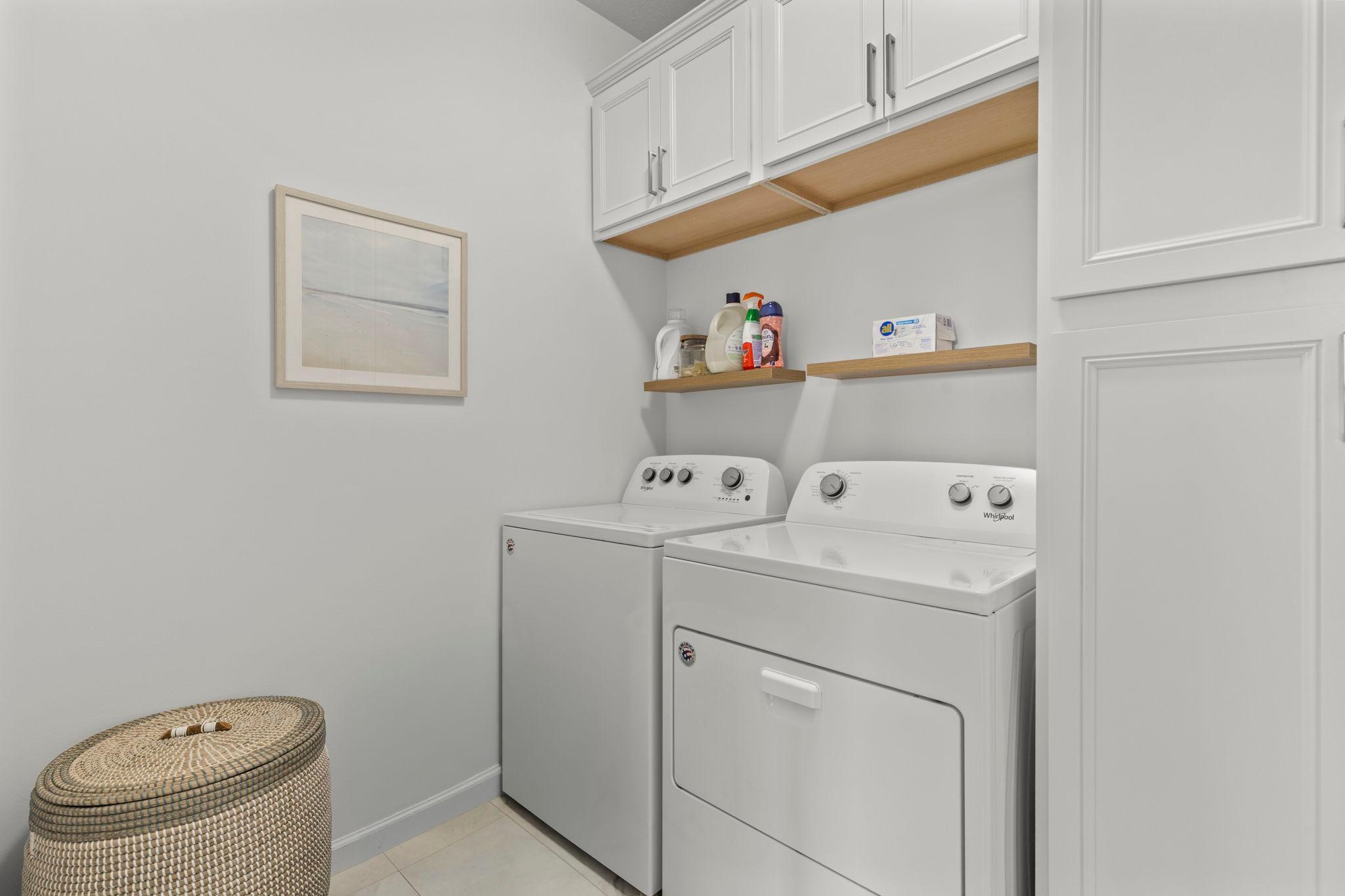 Laundry room offers extra storage as well