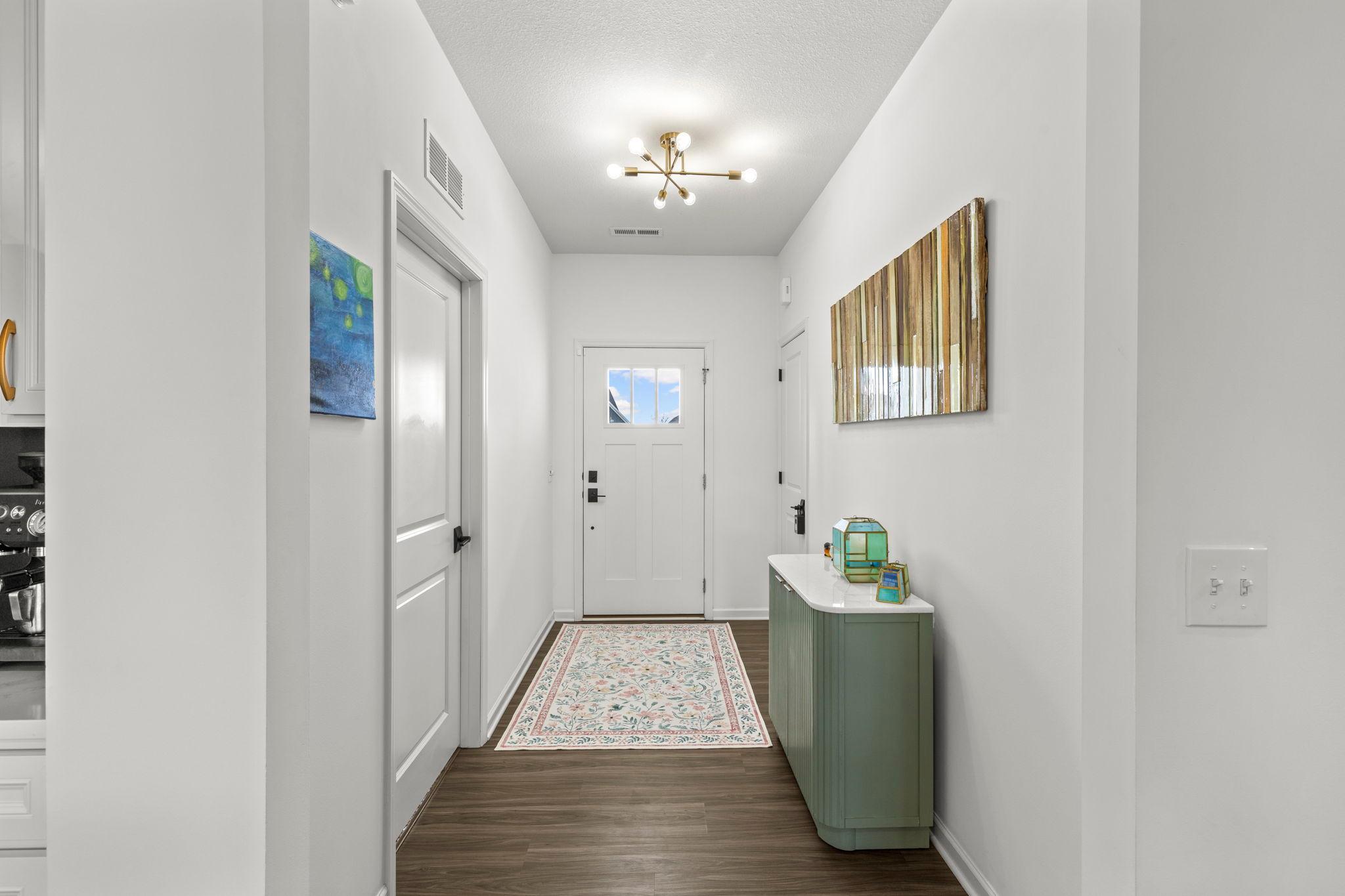 Foyer is clean and bright with LVP flooring and a large closet for convenience