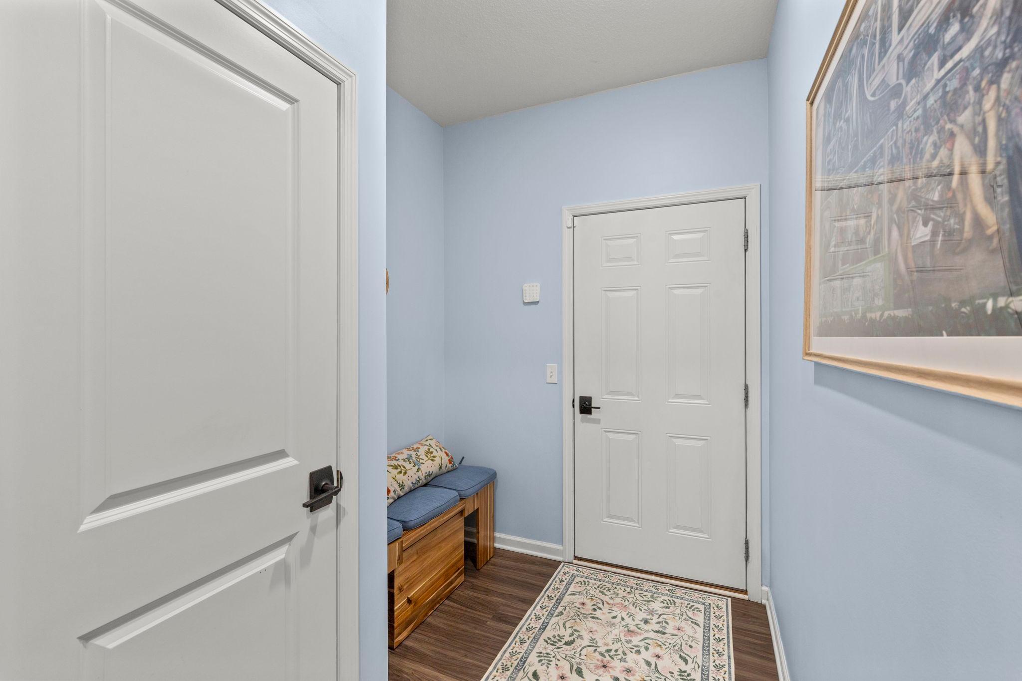 The mudroom offers space for a bench and hooks, providing convenient coat and shoe storage