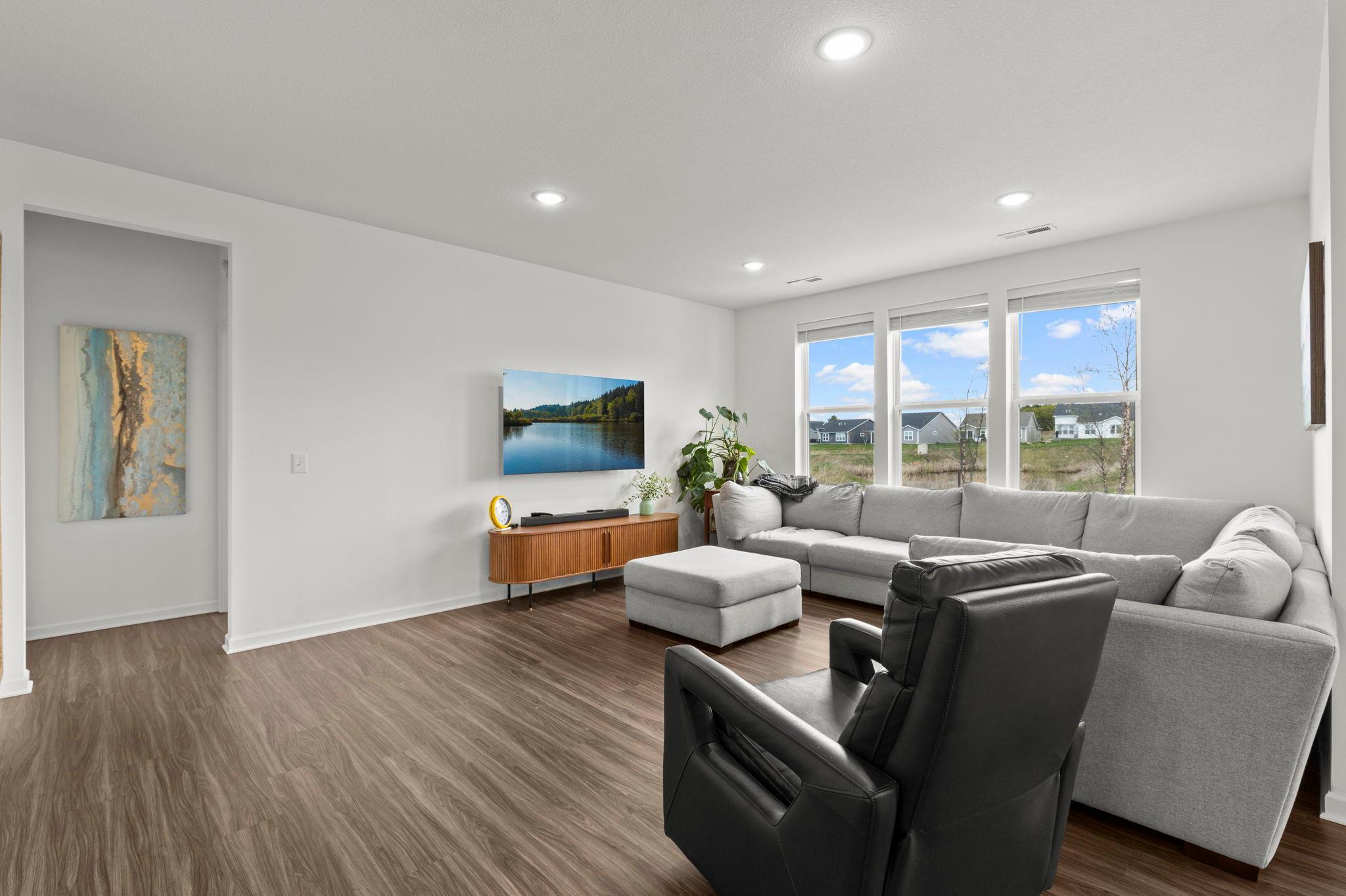 Cozy living room features views of the backyard