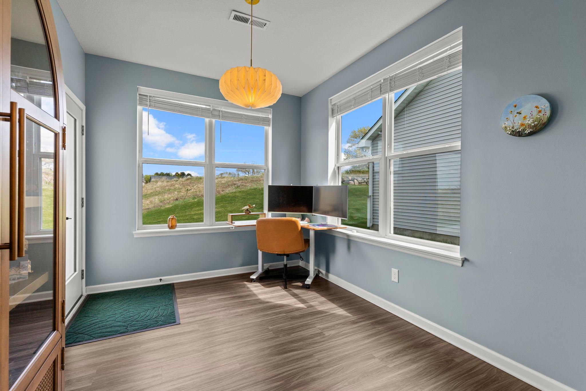 Enjoy a bright sunroom that works beautifully as a home office or flexible living space