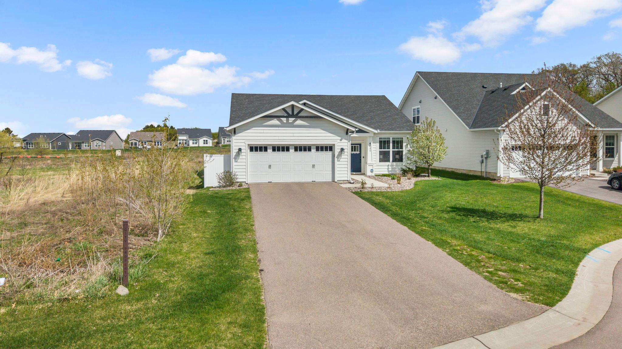 Enjoy the lovely curb appeal with fresh landscaping and a discreet trash enclosure to keep bins neatly hidden