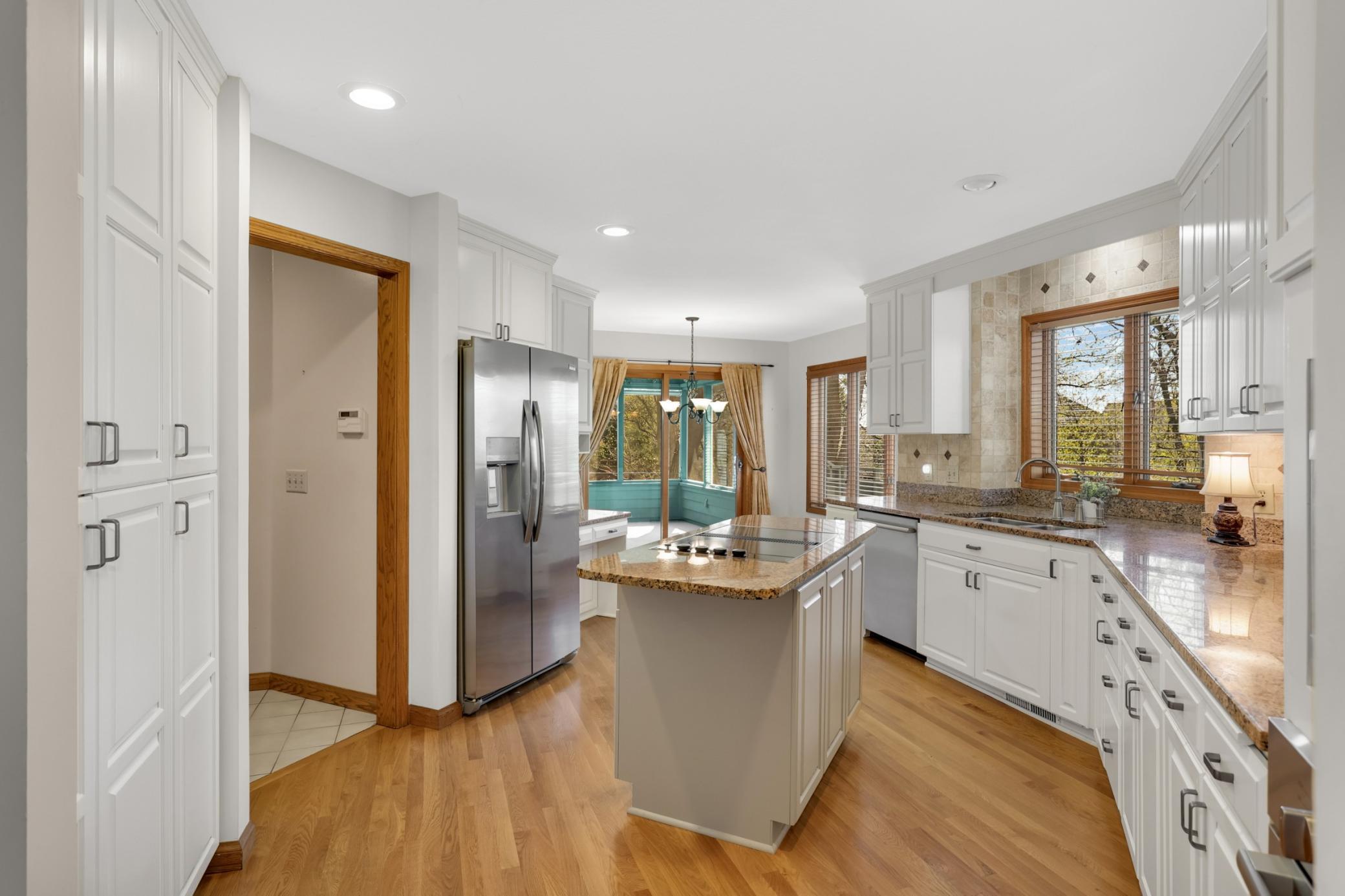 View of kitchen and dining space, screened porch attached to the dining space.