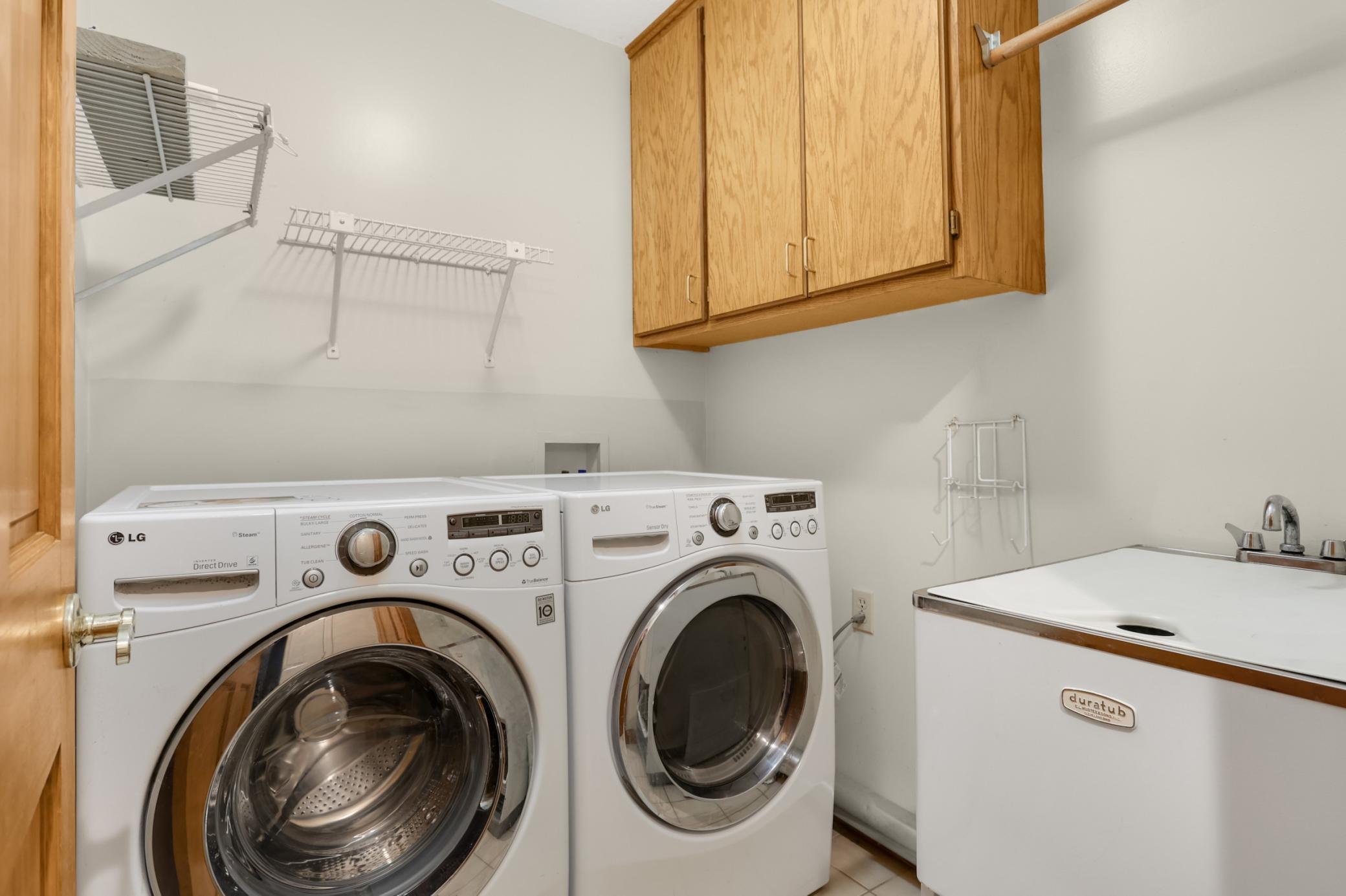 Main floor laundry room and storage cabinets