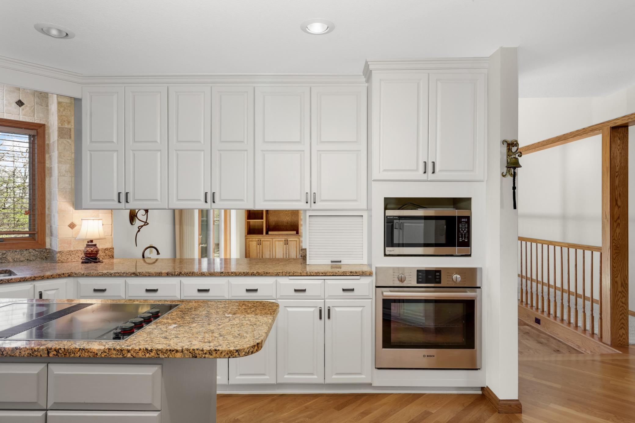 Updated dream kitchen with enameled cabinets, quality granite counters, upper end appliances & wood floors. Open cabinets allow you to view into the main floor family room.