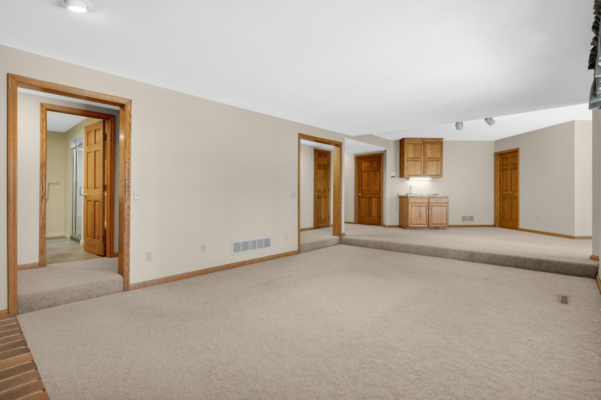 Spacious lower level family room. 2 additional bedrooms are also on this level. Home has so much living space to enjoy on all levels. Nice wet bar is perfect for entertaining.