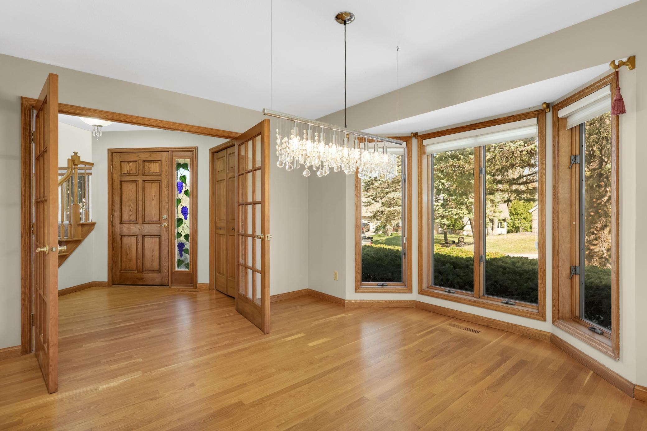 Large dining room is the perfect spot for special meals with family and friends. Large windows, French doors, wood floors and gorgeous chandelier will be the perfect backdrop to the memories you will celebrate in this room.