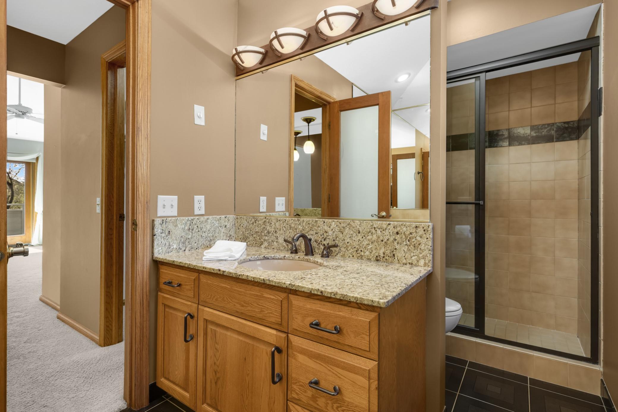 2 separate sinks and vanity areas in this primary bathroom. Separate shower and jetted tub too! Updated and ready to enjoy!