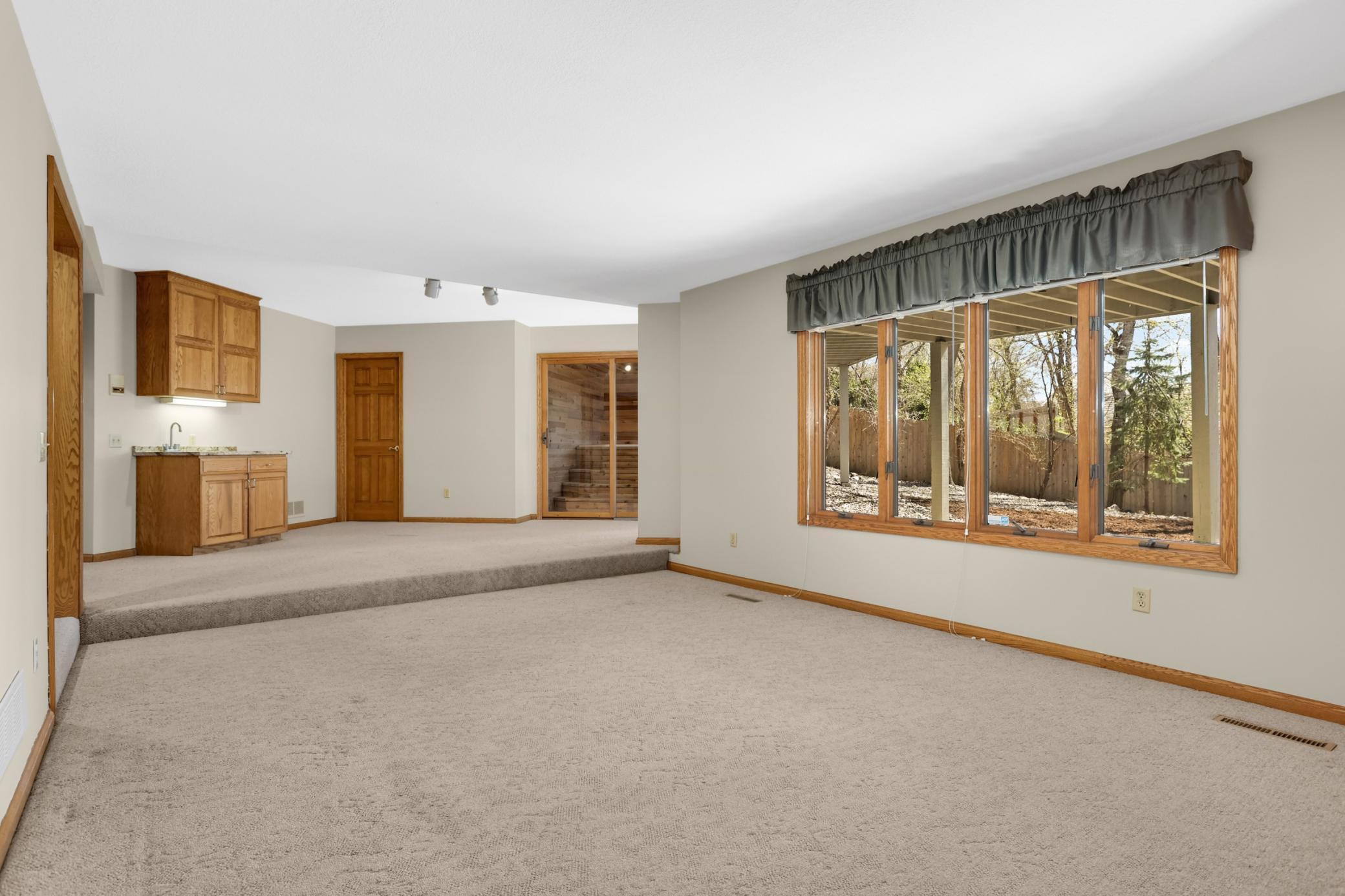 Walk out lower level family rom with nice views of private backyard.