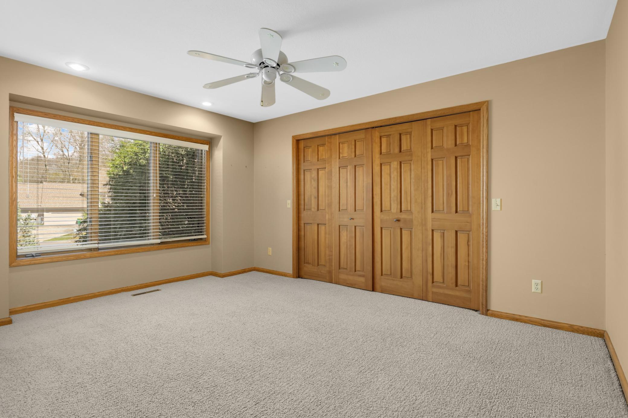 2nd bedroom on main floor with ceiling fan, large closet and private bathroom!