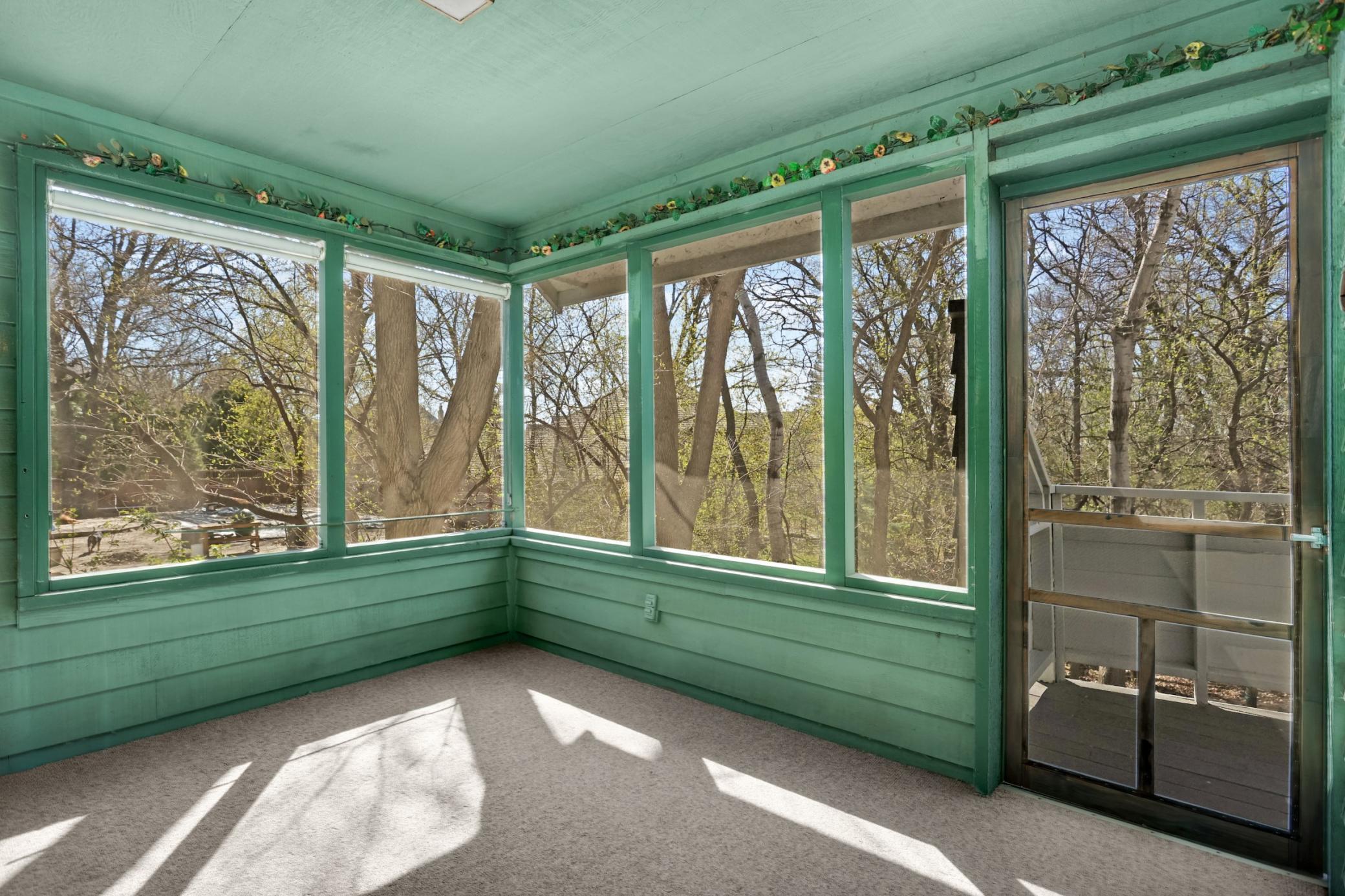 What a fantastic spot to escape in with a good book, coffee or an evening beverage. Door leads to large 55' deck! Tons of mature trees give this space a very private feeling.