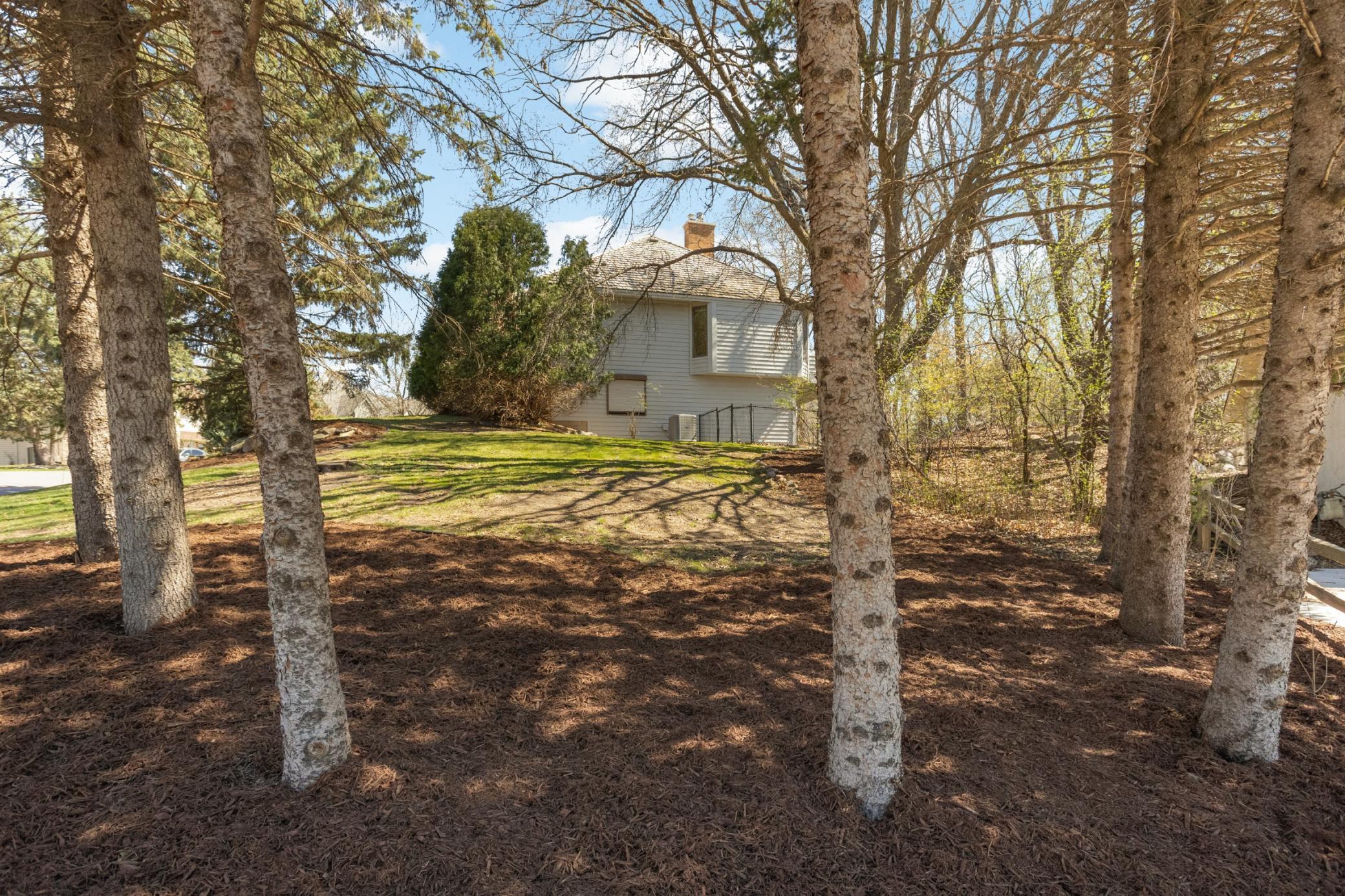 View of home from yard. Fresh mulch just installed! Fenced yard, perfect for a dog!