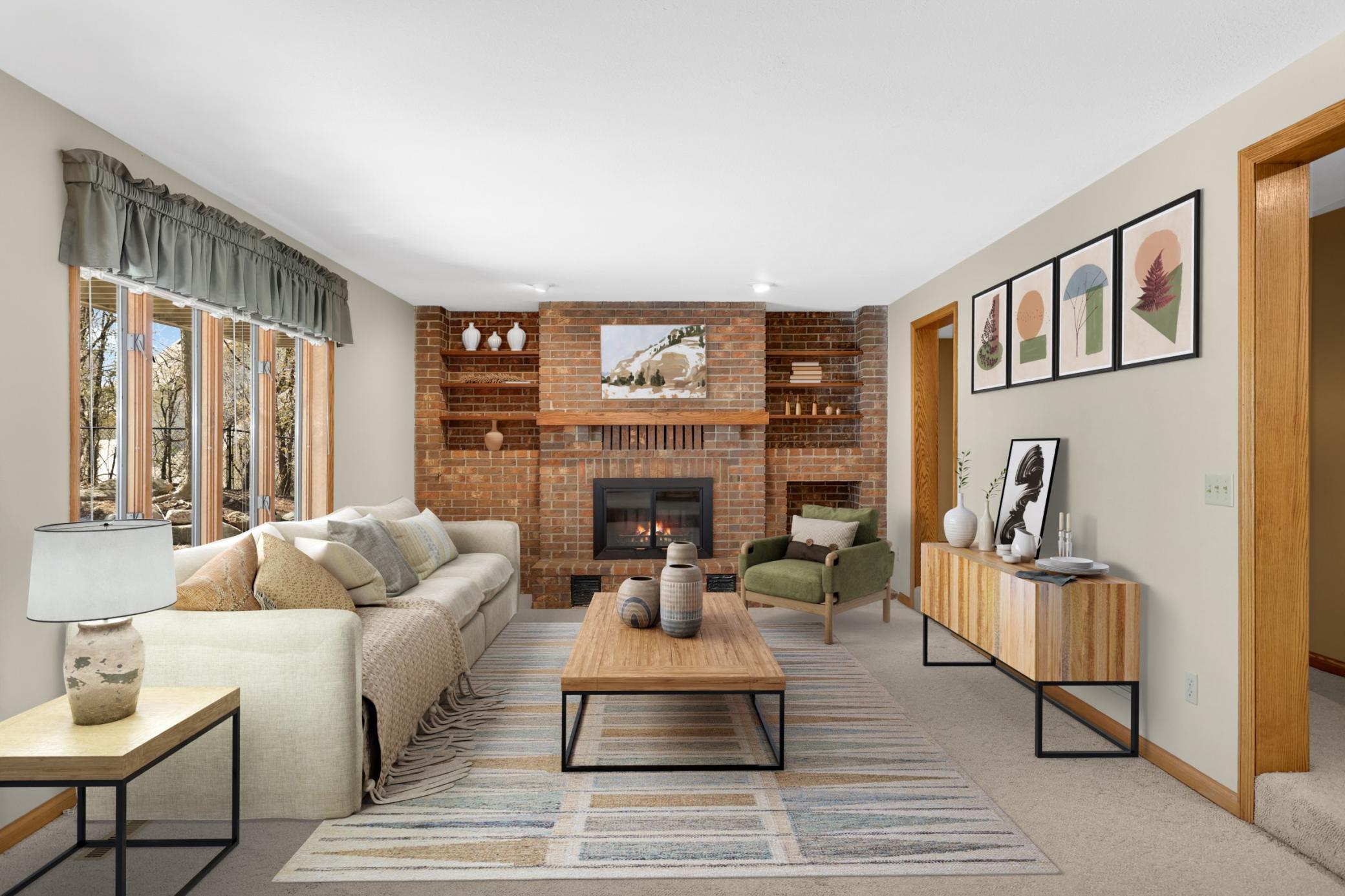 Virtual Staged lower level family room with wood burning fireplace. Lots of windows and room for large furniture if desired.