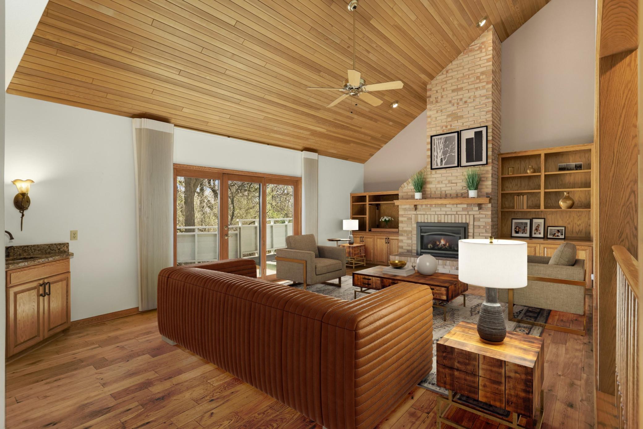 Virtual Staged main floor family room. This room is a show stopper! Vaulted ceiling, built in shelving, wood floors, nice little wet bar and large door that leads to 55' deck. Gas fireplace is perfect for cooler days!