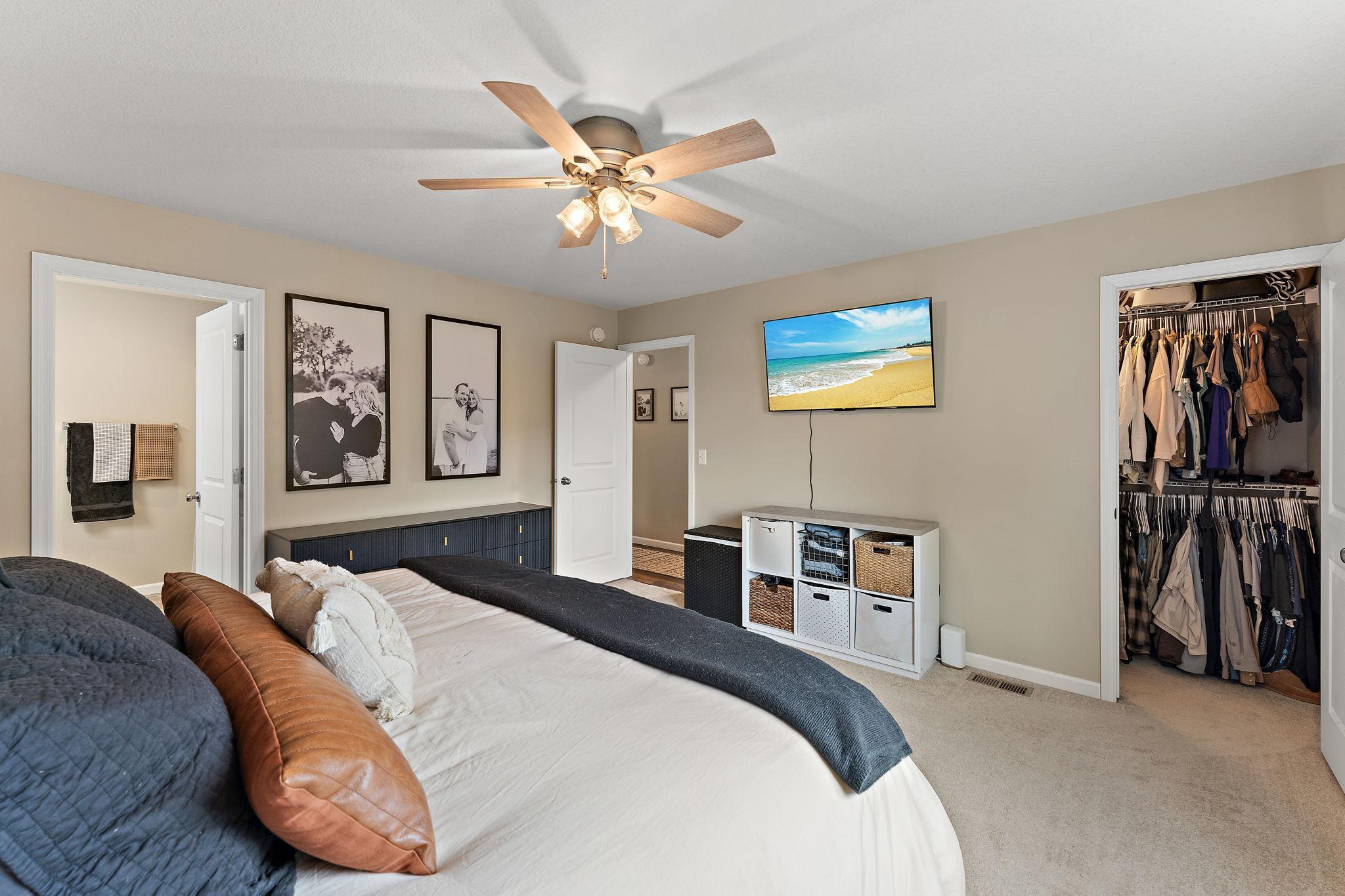 View of closet and private primary bath.