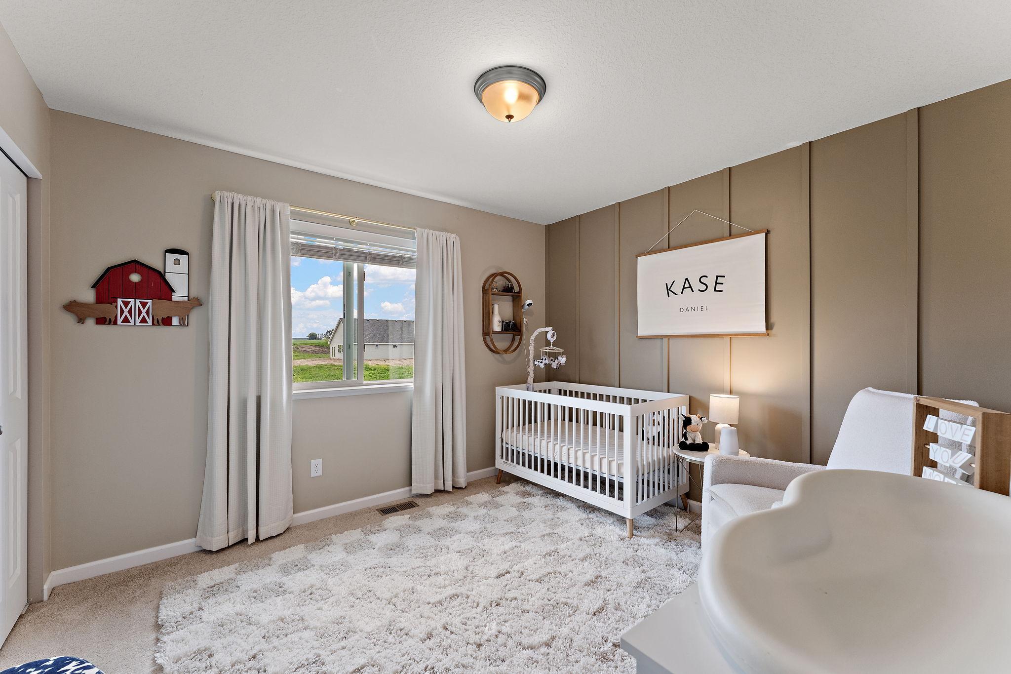 One of three bedrooms on main, carpeted room, accent wall adds depth to room