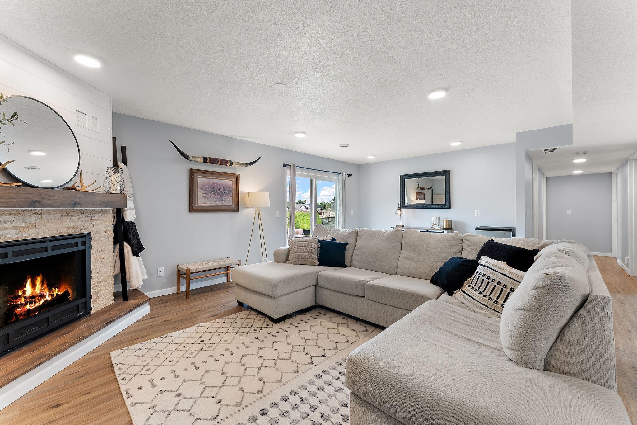 Lower level family room offers plenty of space and walks out to the new patio area, ready for your BBQ! Note the space on the far wall - countertop height outlets are ready for you to add your snack counter and microwave.