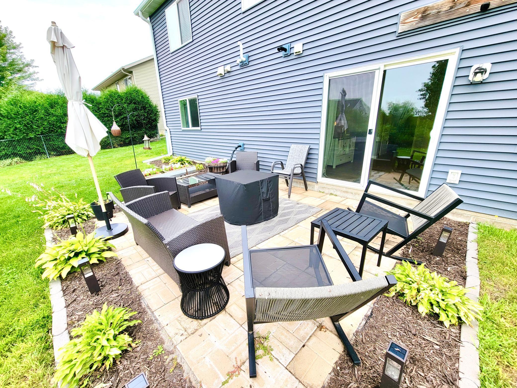 Enjoy the warm weather on the new patio, neatly landscaped