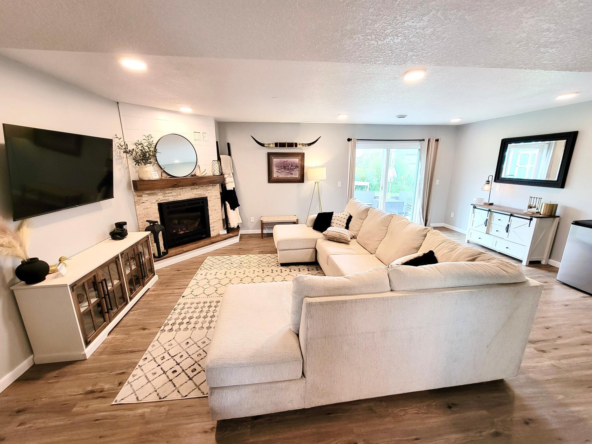 Huge lower level space with room for a snack bar on the wall by the patio door. Note the outlets ready for your countertops.