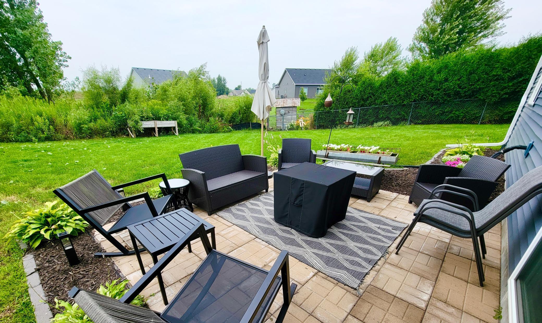 Newly finished patio surrounded by hostas - spacious backyard