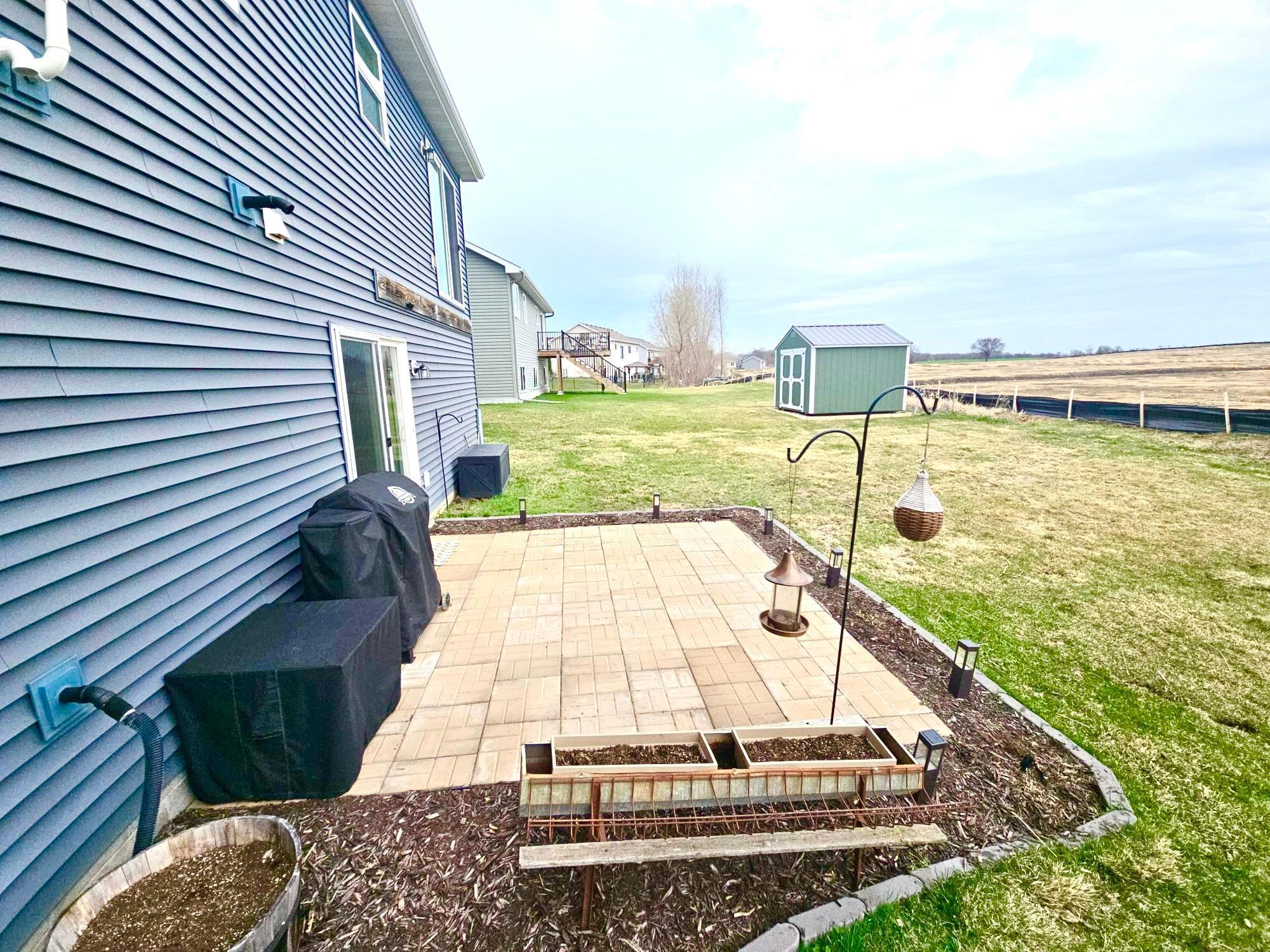 Newly finished patio with perennials to pop up this spring and summer