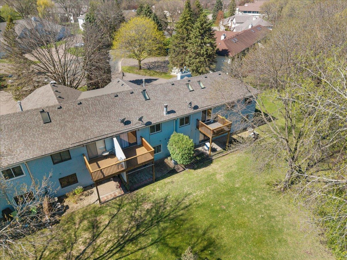 Rear View showing the deck that over looks a beautiful back yard and pond.