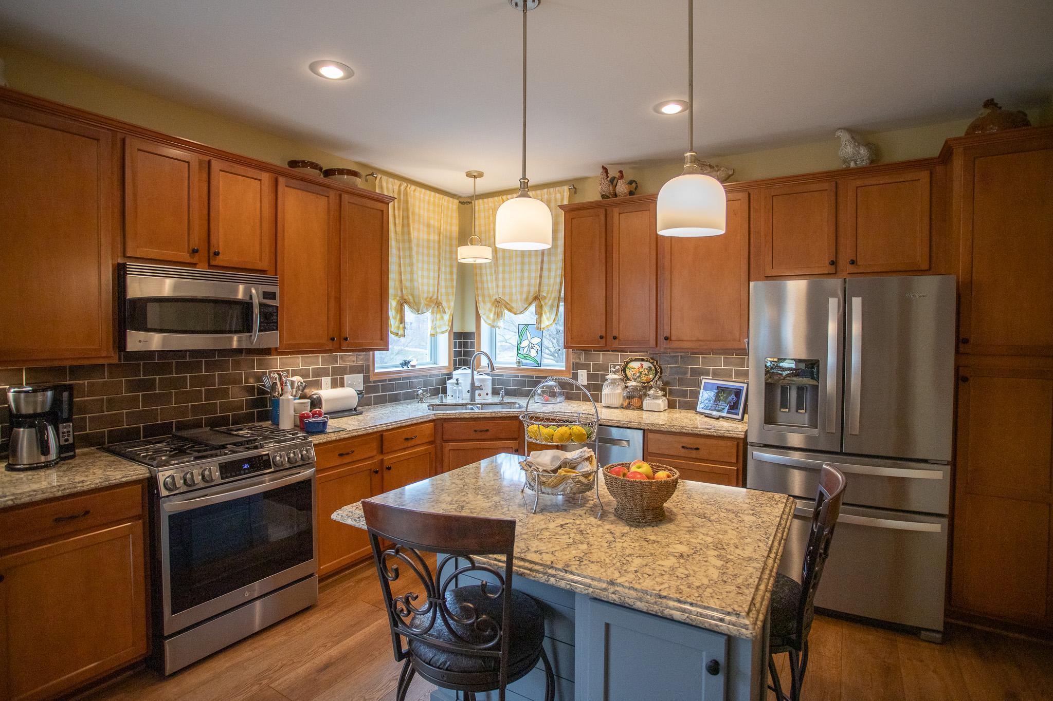 Tile backsplash, stainless appliances, quartz countertops
