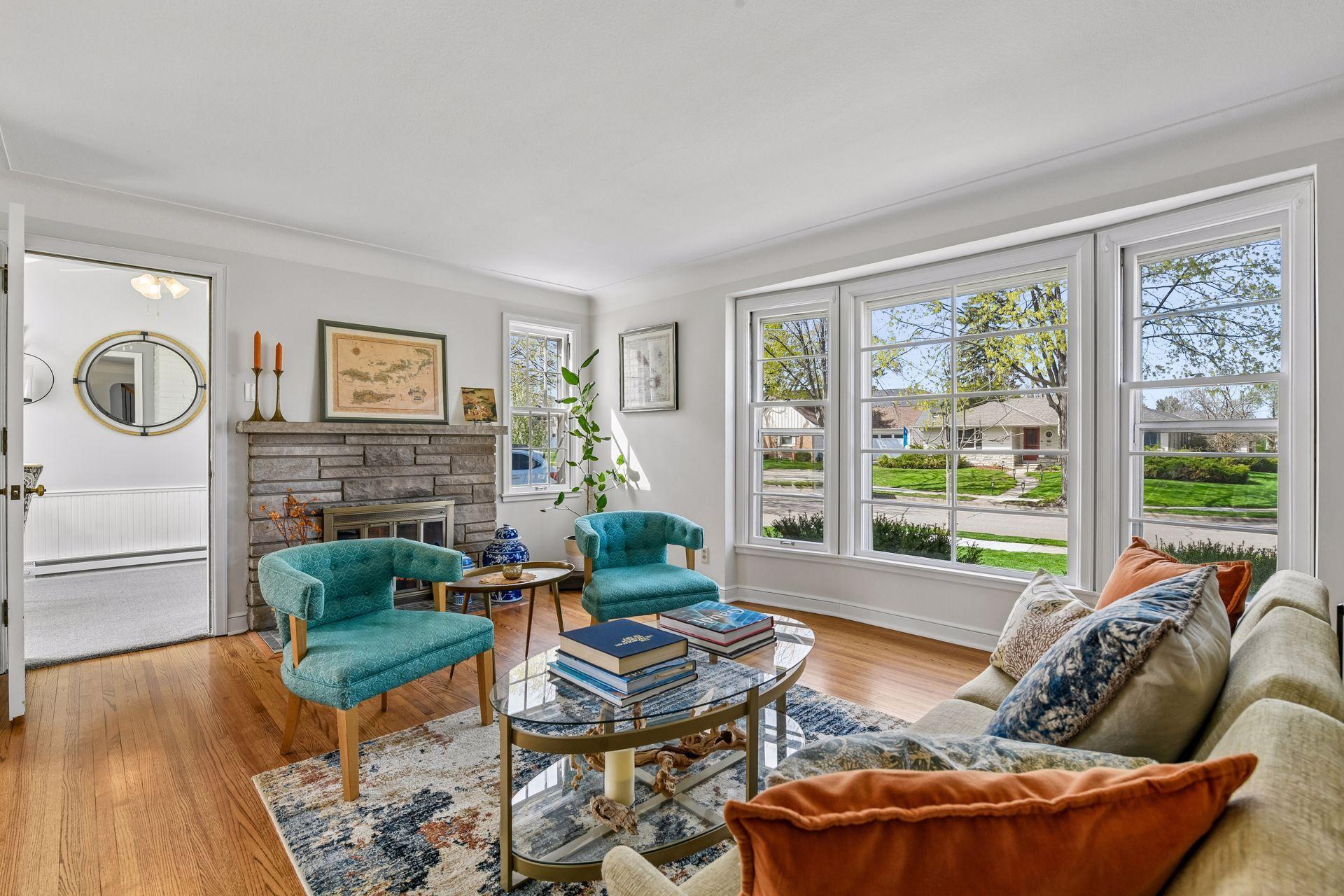 Step inside to the living room featuring a fireplace, classic coved ceilings, and beautiful hardwood floors that flow effortlessly into the dining room.
