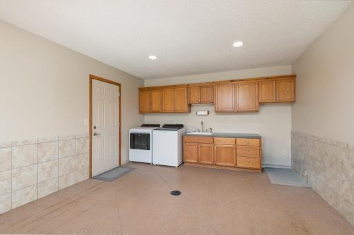 Lower Level flex/utility room off the Family Room has laundry hookups, walks out the the backyard and into the 3 stall garage