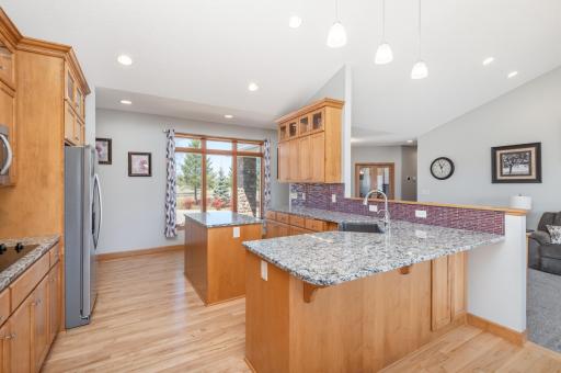 Kitchen with breakfast counter, updated granite countertops and newer stainless appliances