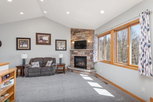 Great Room with gas fireplace & views of the backyard and woods
