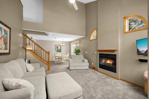 2-story living room with gas fireplace, newer carpet & tons of natural light. End unit offers lots of windows to fill the space with natural light.