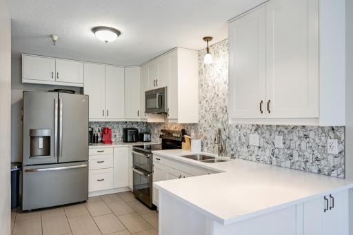 Abundant cabinet and counter space in this kitchen. 1/2 bath and storage closet also near the kitchen.