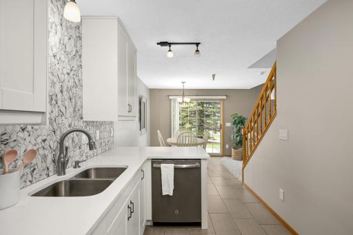 Remodeled kitchen with Quartz counters, new cabinets, new sink and faucet & gorgeous tiled backsplash.