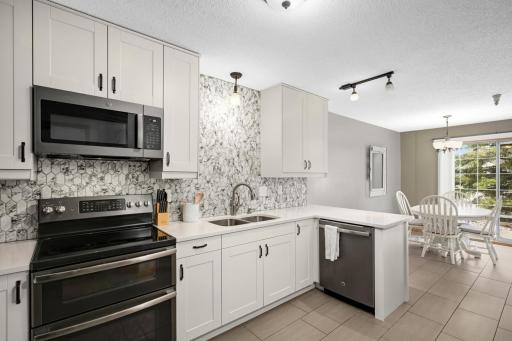 Kitchen has been gutted and remodeled with new cabinets, Quartz counters, tiled backsplash and new sink and faucet. Gorgeous! Lots of cabinet and counter space. Tile flooring is lovely too!