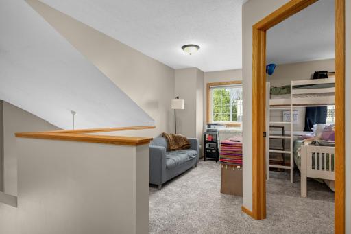 Upper level loft area makes a great office, homework station or extra TV spot. Relax and imagine the possibilities in this sunny nook! Overlooks the living room. New carpet on upper level.