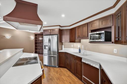 The beautiful kitchen is fully open for entertaining but the higher countertop adds great privacy to your cooking and clean up.