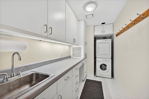 Laundry room has great storage, folding area and sink.