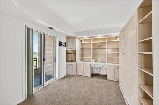 The office/3rd bedroom has French doors and a private balcony. The custom built-in queen size Murphy bed offers flexibility,