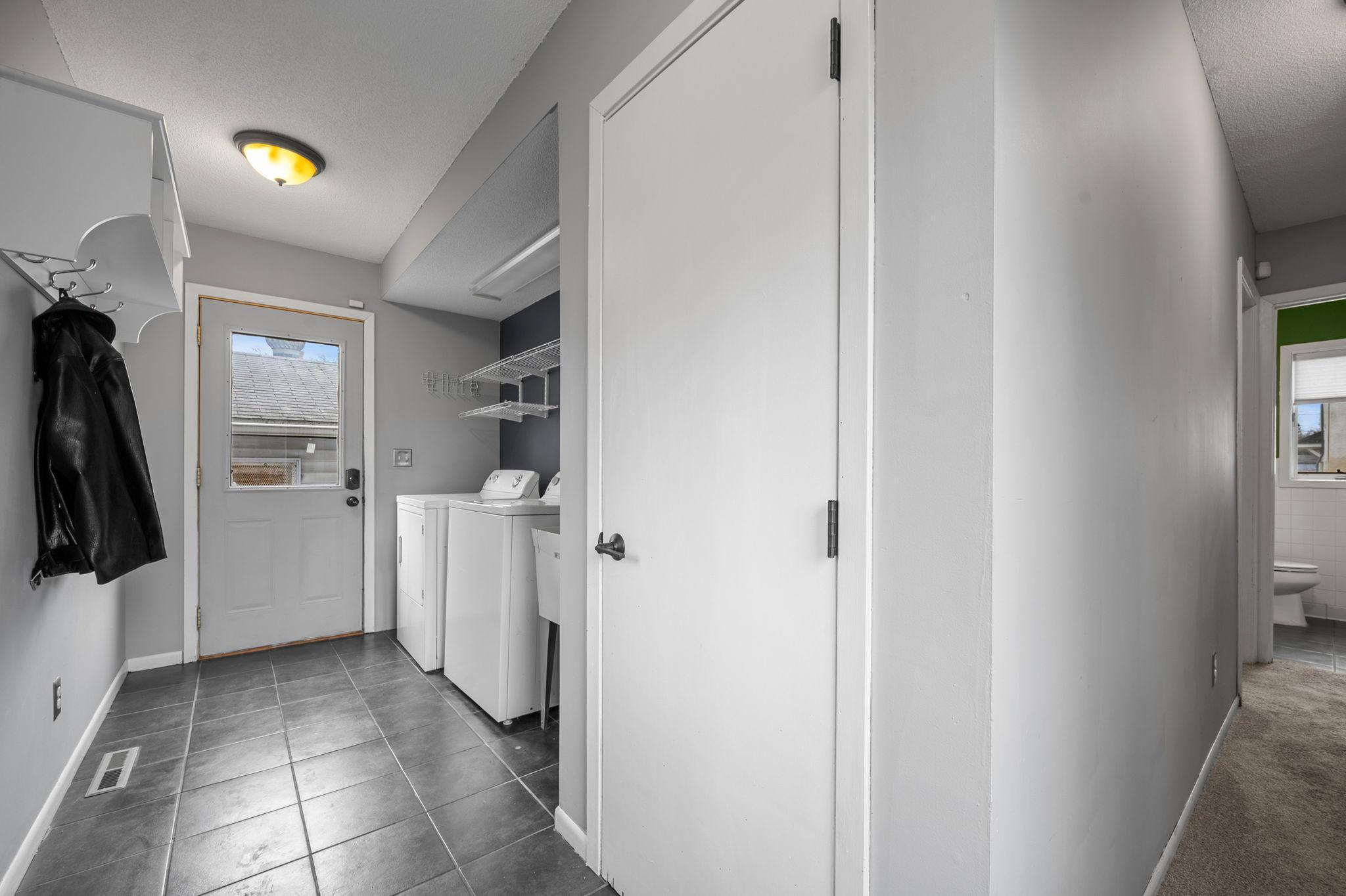 A combined mudroom and laundry room at the rear offers direct outdoor access and side yard access.