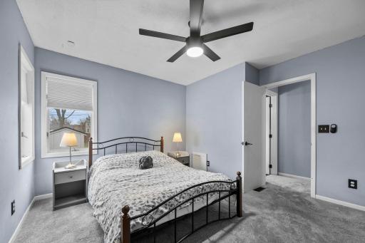 The second bedroom offers added privacy, a large closet with built-ins, and views of the side and backyard.
