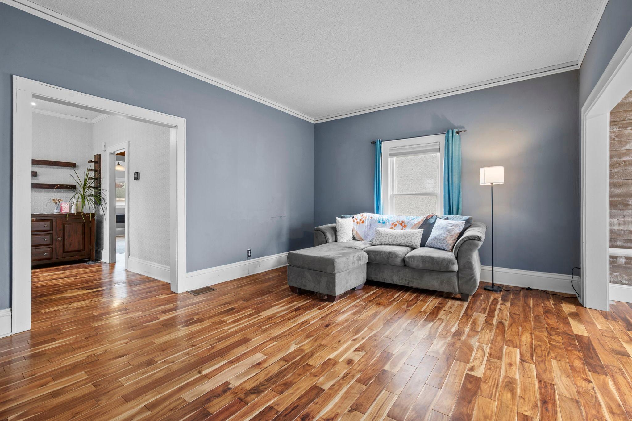 Large windows fill the living room with abundant natural light.