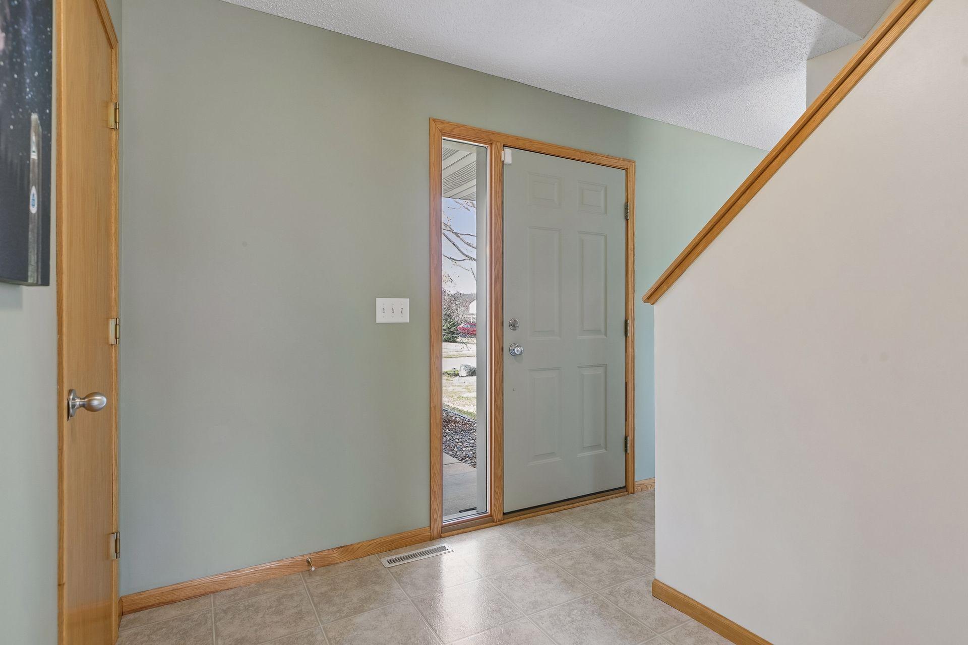 49 Windsor Wood Path - Front entry area features door with sidelight that adds even more natural light to the nearby areas with large new windows.